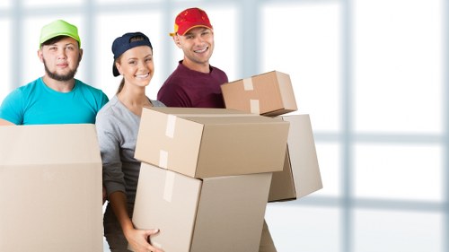 Professional movers carrying furniture down stairs in Tufnell Park
