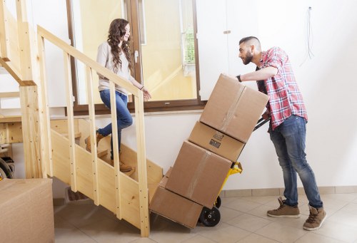 Packing boxes and furniture being loaded into a van in North London