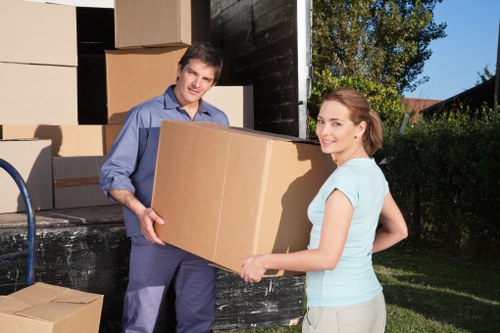 Trained removals staff handling items carefully during loading
